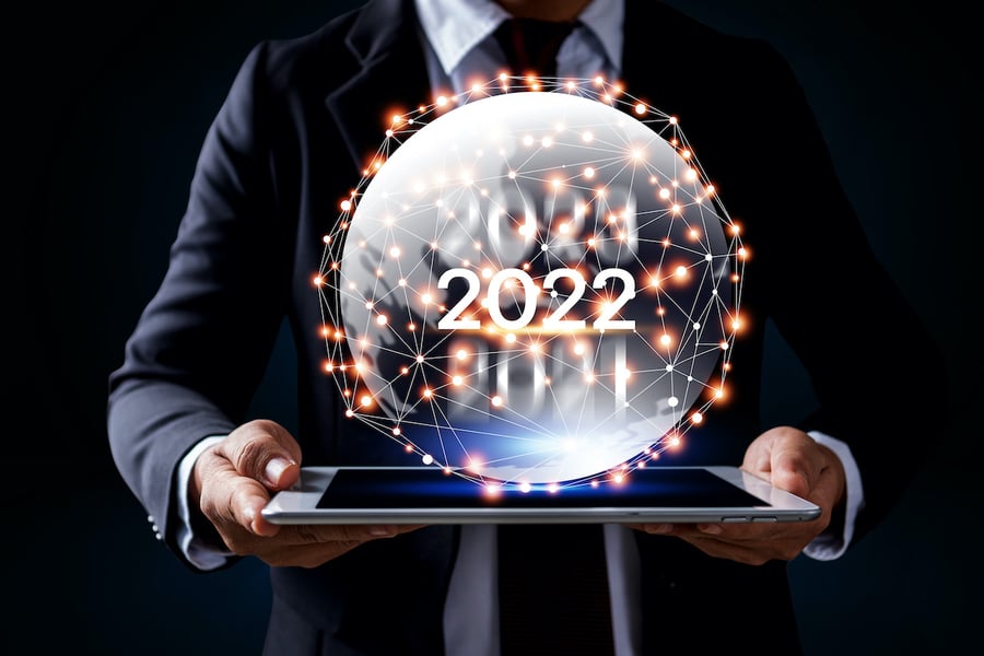financial advisor holding a digital representation of 2022 on a tablet