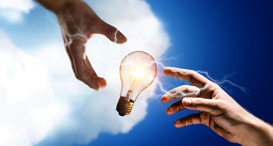 2 different financial advisor hands holding a light bulb representing the idea of brand awareness