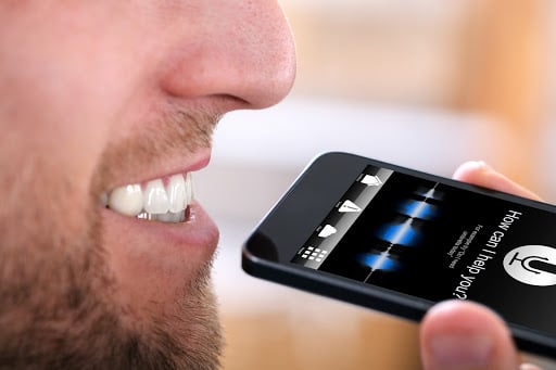 man using voice search on smartphone