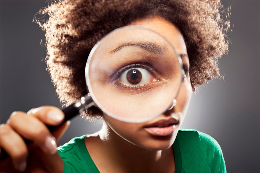 viewing financial advisor website through magnifier