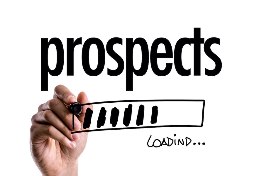 a finger holding a black pen writing the word prospects on a white board