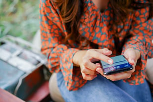 gen x investor scanning through financial advisor social media accounts on her smart phone