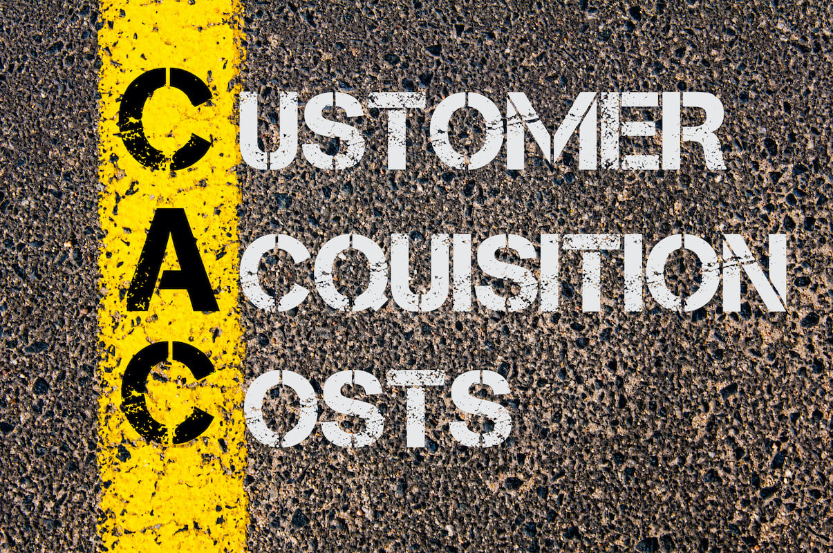 the words customer acquisition costs written on the pavement