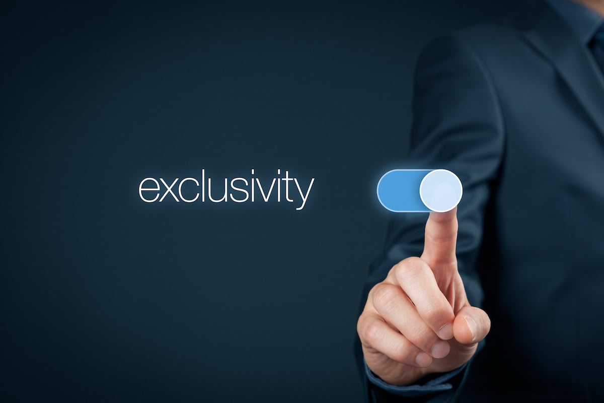 financial advisor pointing with his finger to the word exclusivity